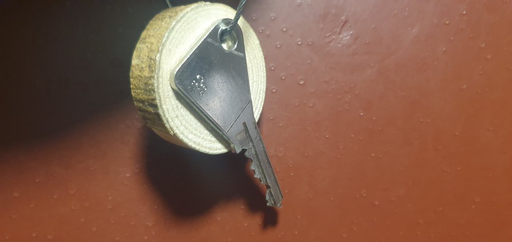 key hanging from wood
